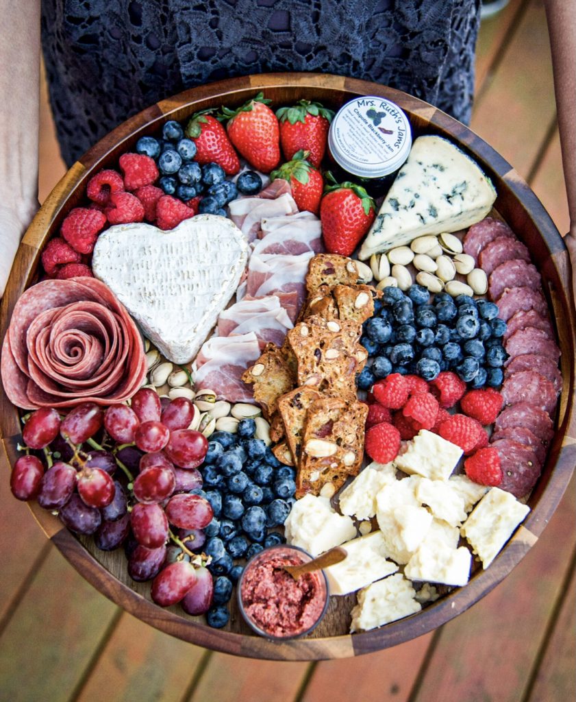 Valentines' Day Theme Cheeseboard with a heart-shaped cheeese, salami rose, and lots of berries